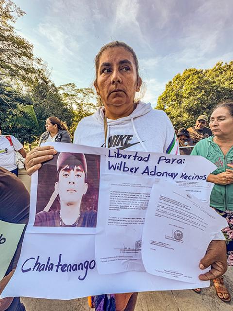 María Estela Ramos, of Guarjila, El Salvador, holds a sign Jan. 12, 2025, in downtown San Salvador, showing documents that show her son has no criminal record. She says he has been wrongfully imprisoned by the Salvadoran government. (NCR photo/Rhina Guidos)