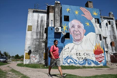 A man walks past a mural of Pope Francis in Buenos Aires, Argentina, Feb. 19, 2025, as the Archdiocese of Buenos Aires calls on all churches in Argentina to hold Masses for the pontiff’s quick recovery. Matteo Bruni, director of the Vatican press office, told reporters early Feb. 19 that the pope slept peacefully, woke up and had breakfast.