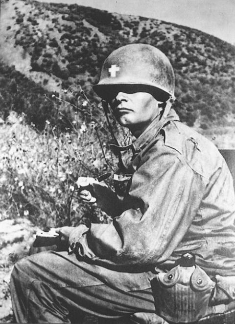 An undated handout photo shows Fr. Emil Kapaun serving in Korea. The U.S. military chaplain died in 1951 in a Chinese-run prison camp. He was 35. (CNS/Courtesy of The Catholic Advance)