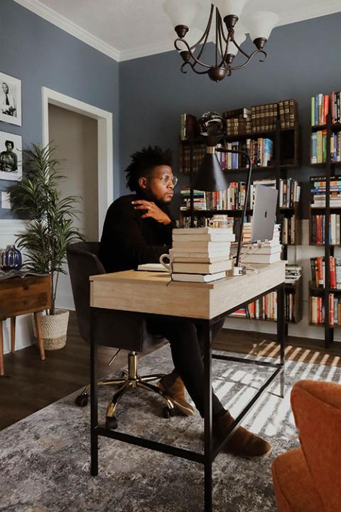 Danté Stewart works in his office. (RNS/CrownedGold Photography/Taja Ambrose)