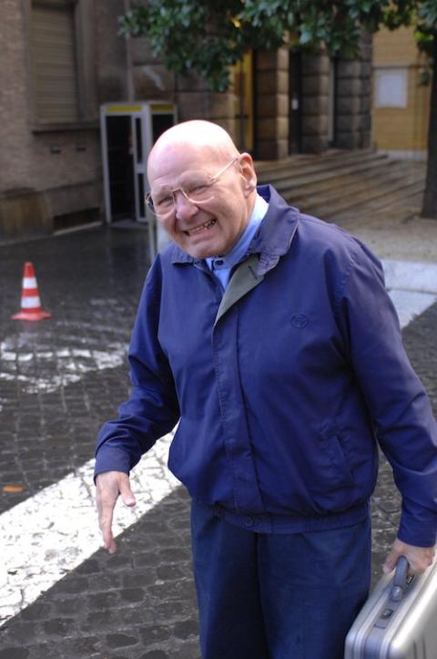 Wearing his trademark blue workman's uniform, Discalced Carmelite Fr. Reginald Foster takes a walk near the Vatican post office in January 2007. (CNS/Chris Warde-Jones)