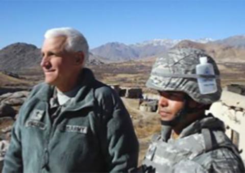 Fr. William Kneemiller, left, says this is his favorite photo from his time as a chaplain in Afghanistan. "I met a soldier who carried holy water attached to his helmet," he recalled. (Courtesy of William Kneemiller)