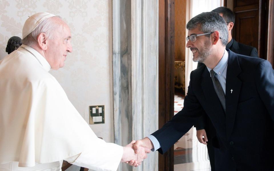 The pope shown shaking Correa's hand.