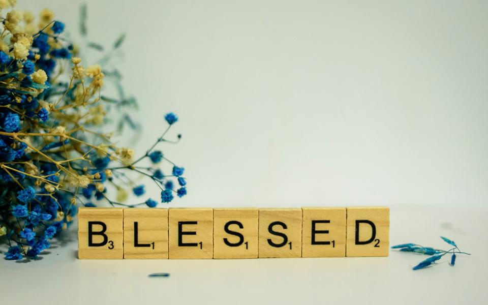 Block tiles spell out the word "Blessed" (Unsplash/Alex Shute)