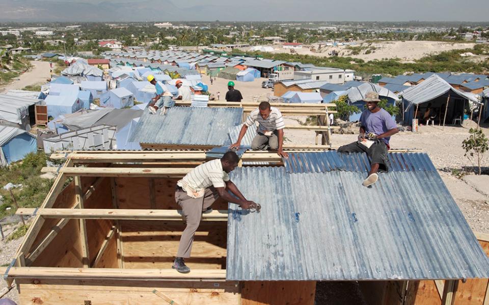 Workers at a camp in Terrain Toto, Haiti, construct transitional shelters provided by Catholic Relief Services for those left homeless in the 2010 earthquake. Catholic Relief Services was among the humanitarian entities deeply affected by USAID cuts. (OSV News/Bob Roller)