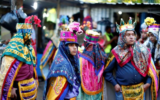 Members of the traditional group of "Los Historiantes" gather outside a house as they celebrate the feast of the Epiphany Jan. 6, 2019, in San Salvador, El Salvador. (CNS/Reuters/Jose Cabezas)