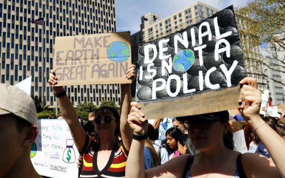 Young women hold signs while participating in the Global Climate Strike in New York City Sept. 20. (CNS/Gregory A. Shemitz)