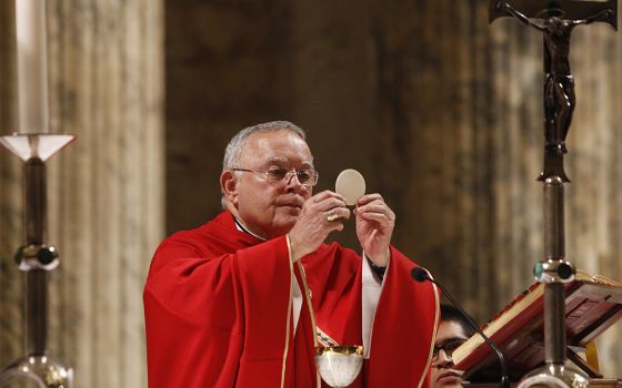 Archbishop Charles Chaput elevates the Eucharist as U.S. bishops from New Jersey and Pennsylvania concelebrate Mass at the Basilica of St. Paul Outside the Walls in Rome Nov. 27, 2019. (CNS/Robert Duncan)