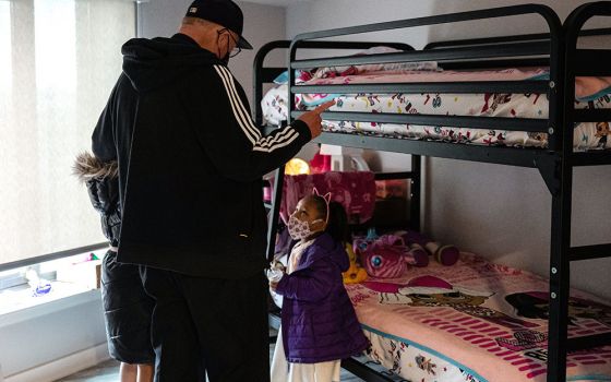 New York Cardinal Timothy Dolan visits Second Farms housing complex in the Bronx borough of New York City on Holy Thursday April 1. The new building opened by Catholic Charities of the Archdiocese of New York has 319 units of affordable housing.