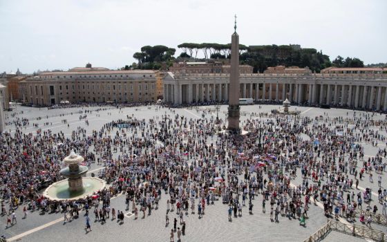 The crowd watches as Pope Francis leads the Angelus message from the window of his studio overlooking St. Peter's Square at the Vatican Aug. 1. (CNS/Vatican Media)