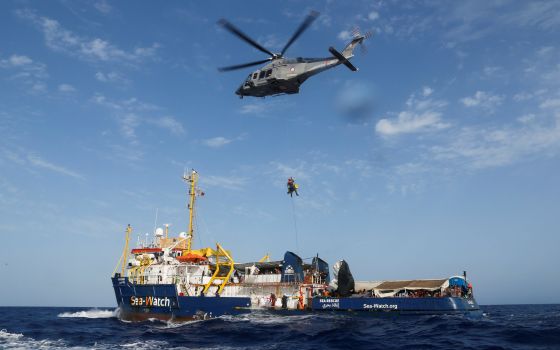 An Armed Forces of Malta helicopter medically evacuates a critically ill Libyan boy and his family from the German NGO migrant rescue ship Sea-Watch 3 in the western Mediterranean Sea Aug. 2, 2021. (CNS photo/Darrin Zammit Lupi, Reuters)