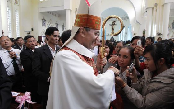 Archbishop Leopoldo Girelli, then nonresident pontifical representative for Vietnam, is greeted by people after Mass at St. Teresa Cathedral in Son Tay, Vietnam, in this Nov. 25, 2011. (CNS photo/Kham, Reuters)