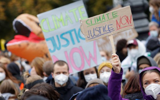 125-page report describes progress on environmental protection and difficulties faced by parishes and other church institutions in responding to climate change. Demonstrators hold signs during the Global Climate Strike of the movement Fridays for Future m