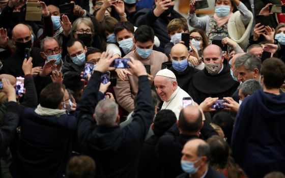 Pope Francis walks through the crowd after his general audience in Paul VI hall at the Vatican Dec. 1, 2021. (CNS photo/Yara Nardi, Reuters)