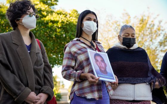 Karen Morales of Honduras talks about her brother, Aaron Eleazar Carrasco Turcios, who went missing nine years ago in Mexico, while standing with other women with the Caravan of Mothers of Disappeared Migrants on Capitol Hill in Washington Oct. 19, 2021. 