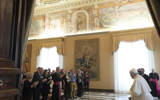 Pope Francis arrives  using a canefor a meeting with elected officials from France 