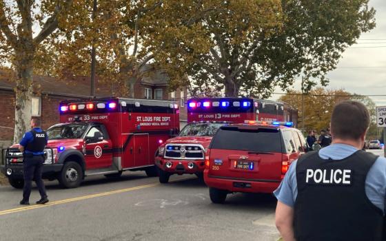 A view shows St. Louis Fire Department vehicles and a police officer