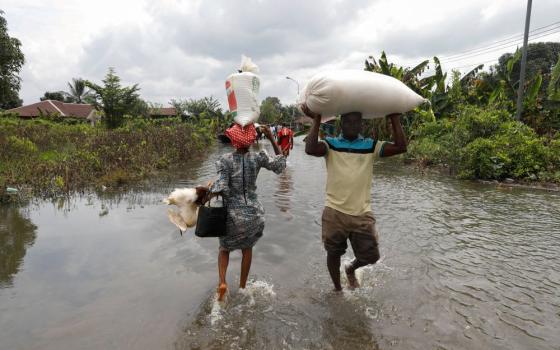 Residents wade through floodwater in Ahoada, Nigeria, Oct. 22, 2022. (CNS/Reuters/Temilade Adelaja)