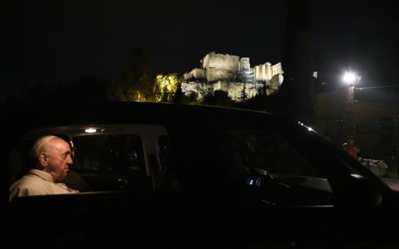 Pope Francis makes a brief stop to admire the Acropolis, the site of the Parthenon, in Athens, Greece, in this Dec. 4, 2021, file photo. The pope will give the three marble fragments from the Parthenon that have been housed in the Vatican Museums to Archbishop Ieronymos II of Athens and all Greece. (CNS photo/Vatican Media)