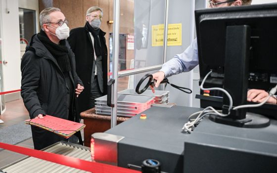 German Archbishop Stefan Hesse of Hamburg enters the security check on his way to the abuse trial at Cologne Regional Court Jan. 18, 2022. (CNS photo/Julia Steinbrecht, KNA)