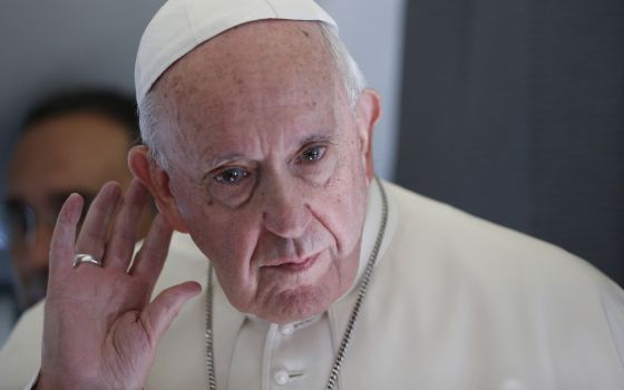 Pope Francis listens to a question while responding to journalists aboard his flight from Tallinn, Estonia, to Rome Sept. 25, 2018. (CNS/Paul Haring)