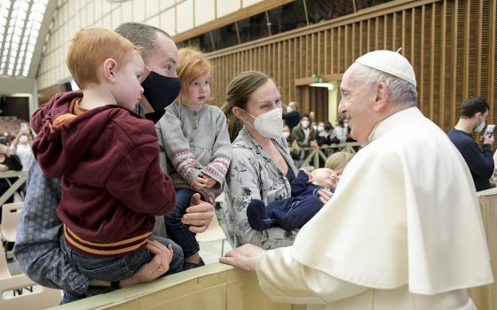 Pope Francis greets family members during his general audience in the Paul VI hall at the Vatican Feb. 9, 2022. (CNS photo/Vatican Media)