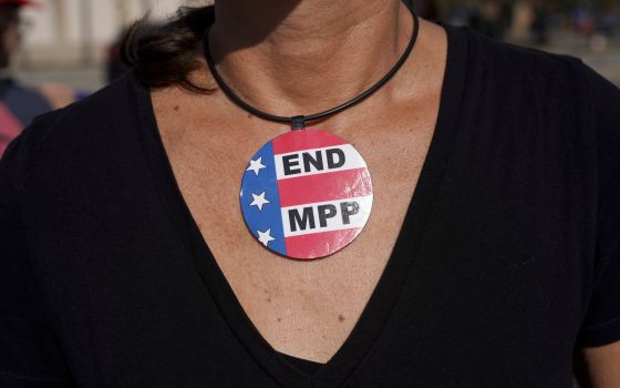 A demonstrator outside a U.S. Customs and Border Protection building in Brownsville, Texas, wears a necklace that reads "END MPP," to protest against Migrant Protection Protocols Jan. 12, 2020. (CNS photo/Go Nakamura, Reuters)