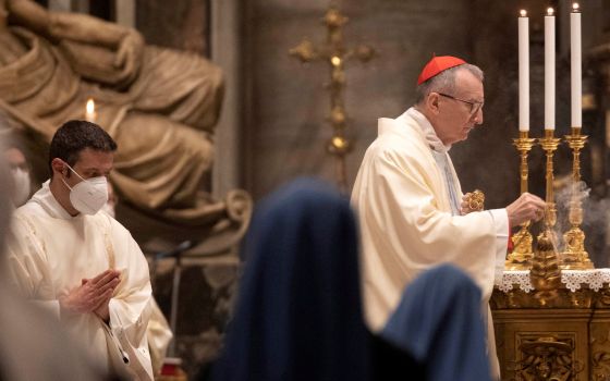 Cardinal Pietro Parolin, Vatican secretary of state, spreads incense during Mass in St. Peter's Basilica at the Vatican Jan. 1, 2021. (CNS photo/Alessandra Tarantino, pool via Reuters)