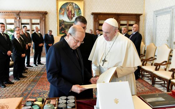 Pope Francis exchanges gifts with Lebanese President Michel Aoun during a private meeting at the Vatican March 21, 2022. (CNS photo/Vatican Media via Reuters)