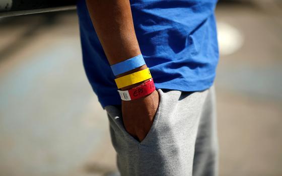 Bracelets used by the U.S. Border Patrol are seen on the arm of a Central American migrant near the Paso del Norte international border bridge in Ciudad Juarez, Mexico, Oct. 1, 2021.