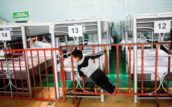 A migrant child plays inside the Kiki Romero temporary migrant shelter in Ciudad Juarez, Mexico, Sept. 30, 2021, after being returned to Mexico along with his family under Title 42. (CNS/Reuters/Jose Luis Gonzalez)