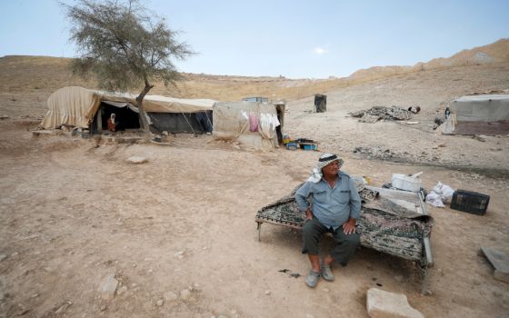 A Palestinian Bedouin sits near his tent near Jericho in the Israeli-occupied West Bank June 27, 2022. (CNS photo/Mohamad Torokman, Reuters)