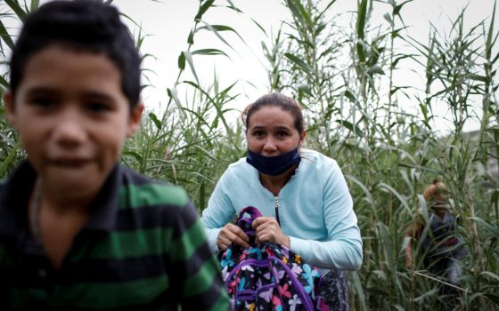 Migrants from Venezuela walk along a trail after crossing the Rio Grande in Del Rio, Texas, May 23, 2022. (CNS photo/Marco Bello, Reuters)