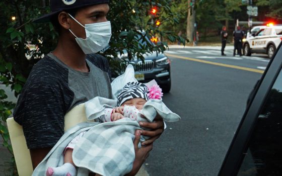 A 1-month-old baby is placed into a vehicle for transport to a safe place in Washington Sept. 17, 2022. after a group of mainly Venezuelan migrants arrived by bus from detention in Texas and were dropped off outside the Naval Observatory