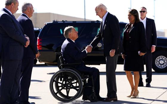 U.S. President Joe Biden shakes hands with Texas Gov. Greg Abbott upon Biden's arrival to the U.S.-Mexico border to assess border enforcement operations Jan. 8 in El Paso. (OSV News/Reuters/Kevin Lamarque)