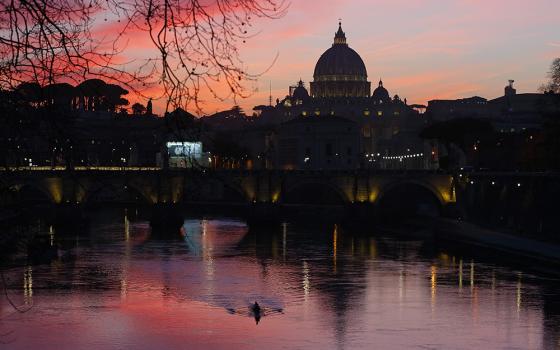 St. Peter's Basilica is seen across the Tiber River March 5, 2019, as the sun sets in Rome. (CNS/Paul Haring)