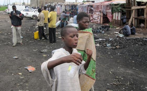 Children roam a street in Lusaka, Zambia, in this undated photo. Countries such as Zambia that are struggling with their sovereign debt would benefit from a new bill in New York that would require vulture funds to play by the same rules as other creditors. (CNS/The Catholic Spirit/Carol McBrady)