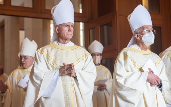 Bishop Joseph E. Strickland of Tyler, Texas, left, and second from left, and Bishop Mark J. Seitz of El Paso, Texas, process out of the Co-Cathedral of the Sacred Heart in Houston Dec. 31, 2021, following the funeral Mass of Galveston-Houston Auxiliary Bishop George A. Sheltz.