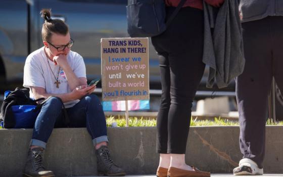 A young demonstrator sits during a protest rally outside the Georgia Capitol in Atlanta March 20.