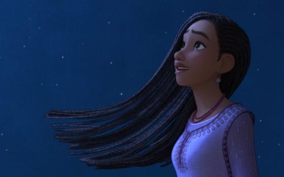 A girl with long hair looks at the sky.