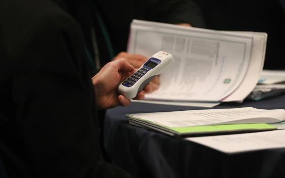 A bishop uses an electronic voting device during a Nov. 14, 2023, session of the fall general assembly of the U.S. Conference of Catholic Bishops in Baltimore. (OSV News/Bob Roller)