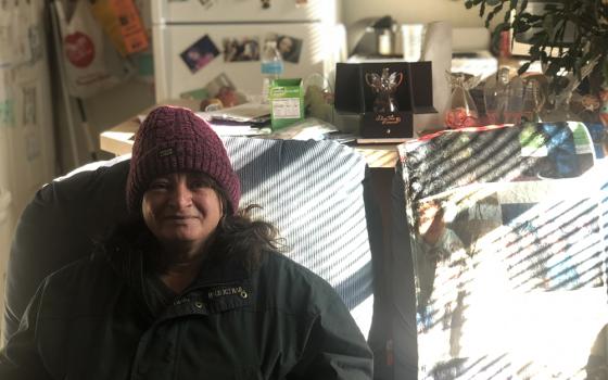 Bonnie McCoy is pictured in her permanent supportive housing unit in Southeast Portland on a recent afternoon. The 56-year-old, who has had four surgeries in two years, lost her housing after a divorce. Chronically homeless individuals frequently are the most medically fragile people in a community who aren't already in a hospital or assisted living, said Robert McCann, president and CEO of Catholic Charities of Eastern Washington. (NCR photo/Katie Collins Scott)