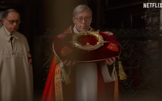 A priest carries the crown of thorns in an image from the Netflix series "Mysteries of the Faith." The relic, held at Notre Dame Cathedral in Paris since the French Revolution, was quickly retrieved from the church when a fire started there April 15, 2019. 