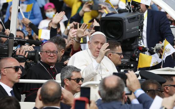 Pope Francis is accompanied by Archbishop Charles Scicluna of Malta as he greets the crowd before celebrating Mass at the Granaries in Floriana, Malta, April 3, 2022. (CNS/Paul Haring)