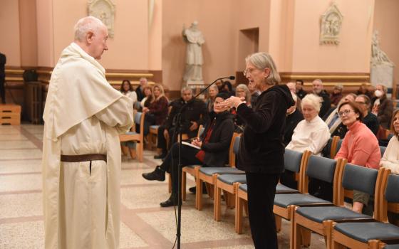 Lucy Robie, a member of St. Thomas the Apostle Parish in Fortville, Indiana, asks a question of Dominican Fr. Timothy Radcliffe