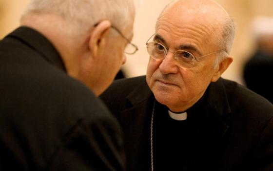 Archbishop Carlo Maria Viganò, then apostolic nuncio to the United States, talks with a U.S. bishop during the bishops' meeting in Baltimore in this Nov. 13, 2012, file photo. 