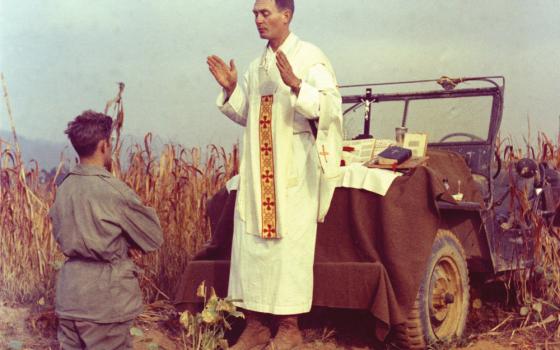 U.S. Army chaplain Fr. Emil Joseph Kapaun, who died May 23, 1951, in a North Korean prisoner of war camp, is pictured celebrating Mass from the hood of a jeep Oct. 7, 1950, in South Korea. (CNS/Courtesy U.S. Army medic Raymond Skeehan)