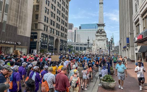 Thousands walk down Meridian Street past the Soldiers and Sailors Monument in Indianapolis July 20 for a Eucharistic procession in conjunction with the National Eucharistic Congress. (OSV News/Peter Jesserer Smith)