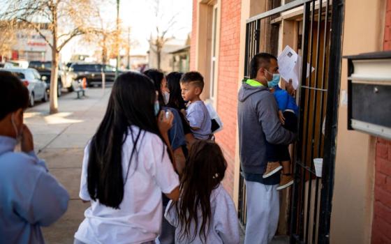 A migrant family is dropped off Dec. 13, 2022, at a local migrant shelter run by the Annunciation House in downtown El Paso, Texas. 