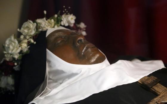 Close up of the exhumed nun's face, wearing habit and crown of roses. 